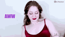 a woman in a red tank top is making a funny face with the word aww in the background