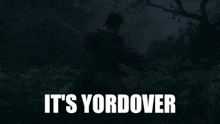 a man is holding another man in a dark forest with the words it 's yordover below him