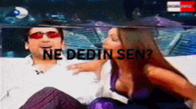 a man and a woman are sitting next to each other with the words ne dedin sen on the screen