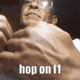 a close up of a man 's hand with the words `` hop on f1 '' on it .