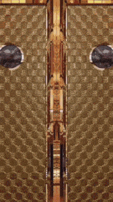 a door with a pattern of circles and x 's is open