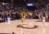 a basketball game is being played in front of a sign that says sheron williams