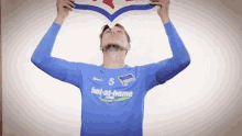 a man wearing a blue bet-at-home jersey