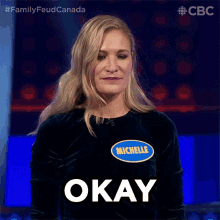 a woman wearing a shirt that says michelle on it says okay