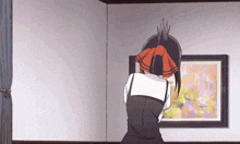 a girl with a red bow in her hair is looking at a picture