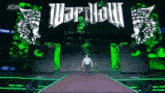 a man walking on a stage with a sign that says " wardlow "