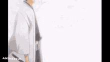a man in a white kimono is holding a sword in his hand .