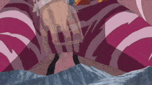 a close up of a person 's hands with a pink and white striped shirt