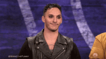 a man in a leather jacket is smiling with the hashtag bringthefunny