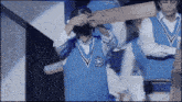a man wearing a blue vest with a badge that says ' harry potter ' on it