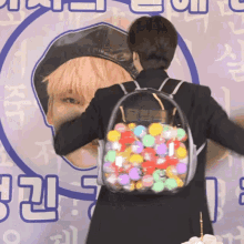 a person wearing a clear backpack with balls inside