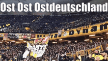 a large crowd of people in a stadium with the words ost ost ost deutschland