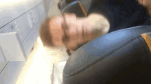 a blurry picture of a man sleeping on an airplane seat