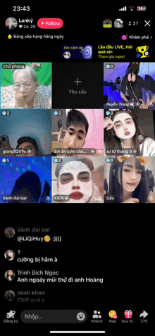 a phone screen shows a group of people with face masks on their faces
