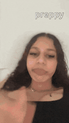 a girl with long hair is making a funny face and the word preppy is on the bottom of the image .