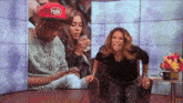 a woman wearing a brooklyn nets sweatshirt sits next to a man