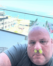 a man wearing ear plugs in his nose takes a selfie