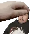 a hand is holding a man 's head in a pixel art .