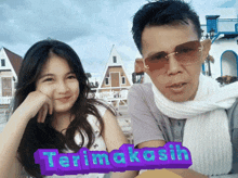 a man and a woman are posing for a picture with the words terimakasih written in purple