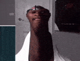 a man with a very long neck is wearing a hat