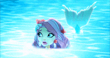 a mermaid with purple hair is swimming in the ocean