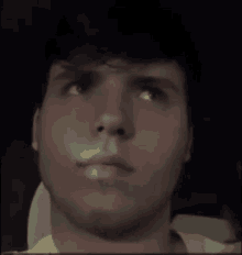 a close up of a man 's face with a yellow shirt