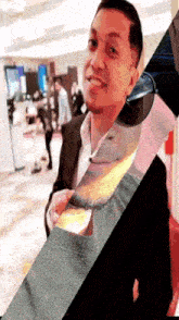 a man in a suit and tie is smiling in a blurry photo