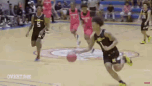 a basketball player is dribbling the ball on a court while a group of players try to stop him .
