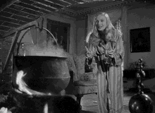 a woman in striped pajamas is standing in front of a cauldron with steam coming out of it