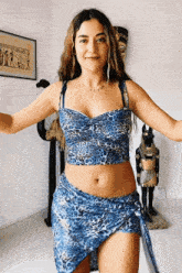 a woman in a blue leopard print top and blue skirt