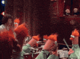 a group of muppets with red hair are playing instruments in a room