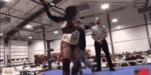 a woman in a wrestling ring is wearing a belt that says ' smackdown ' on it
