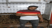 a man in a striped shirt stands in front of a whirlpool air conditioner