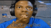 a man wearing headphones and a blue shirt is making a funny face .