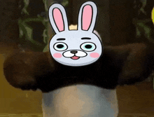 a panda bear with a bunny mask on his head