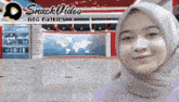 a woman wearing a hijab is smiling in front of a snack video sign