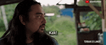 a man with long hair and a beard says kak !