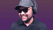 a man wearing headphones and a hat that says ' n ' on it