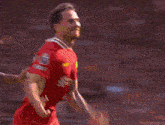 a soccer player in a red jersey with the number 19 on it
