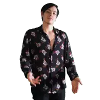a man wearing a black shirt with flowers on it is making a peace sign