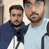 two men with beards are posing for a picture together .