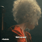 a woman in a red dress is asking what 's her name