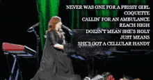 a woman singing into a microphone while playing piano