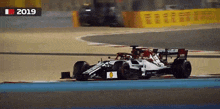 a race car is on a track with the year 2019 on the bottom right
