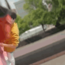 a blurry picture of a man in a yellow shirt hugging another man