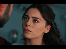 a close up of a woman looking at a man with a beard