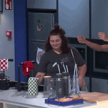 a woman standing in a kitchen wearing a t-shirt that says ' i love you ' on it