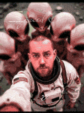 a man in a space suit is surrounded by aliens and the word spaced is visible