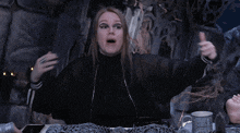 a woman is making a funny face with her hand in her hair