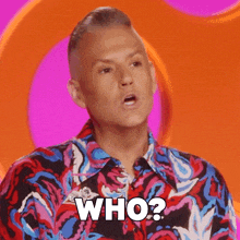 a man wearing a colorful shirt is asking who